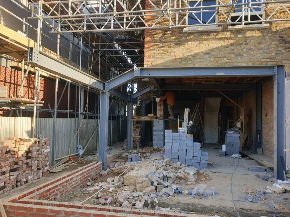 Wide-span goalpost across the back of a house